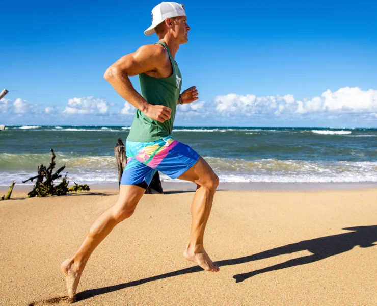 man runs on the beach in an iFIT workout video