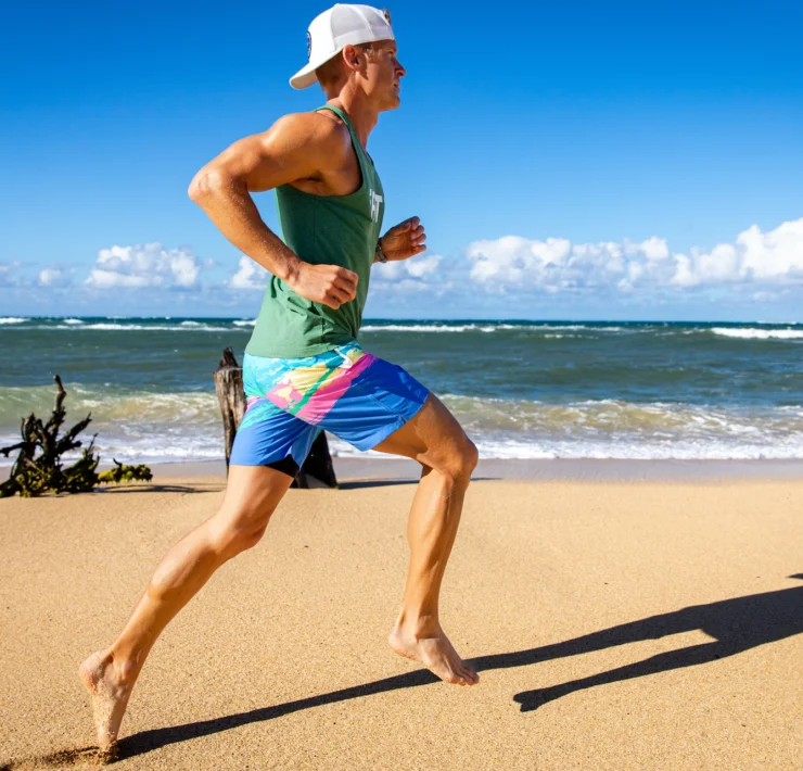 man runs on the beach in an iFIT workout video