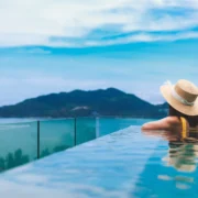 woman in a pool overlooking a mountain
