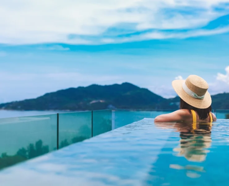 woman in a pool overlooking a mountain