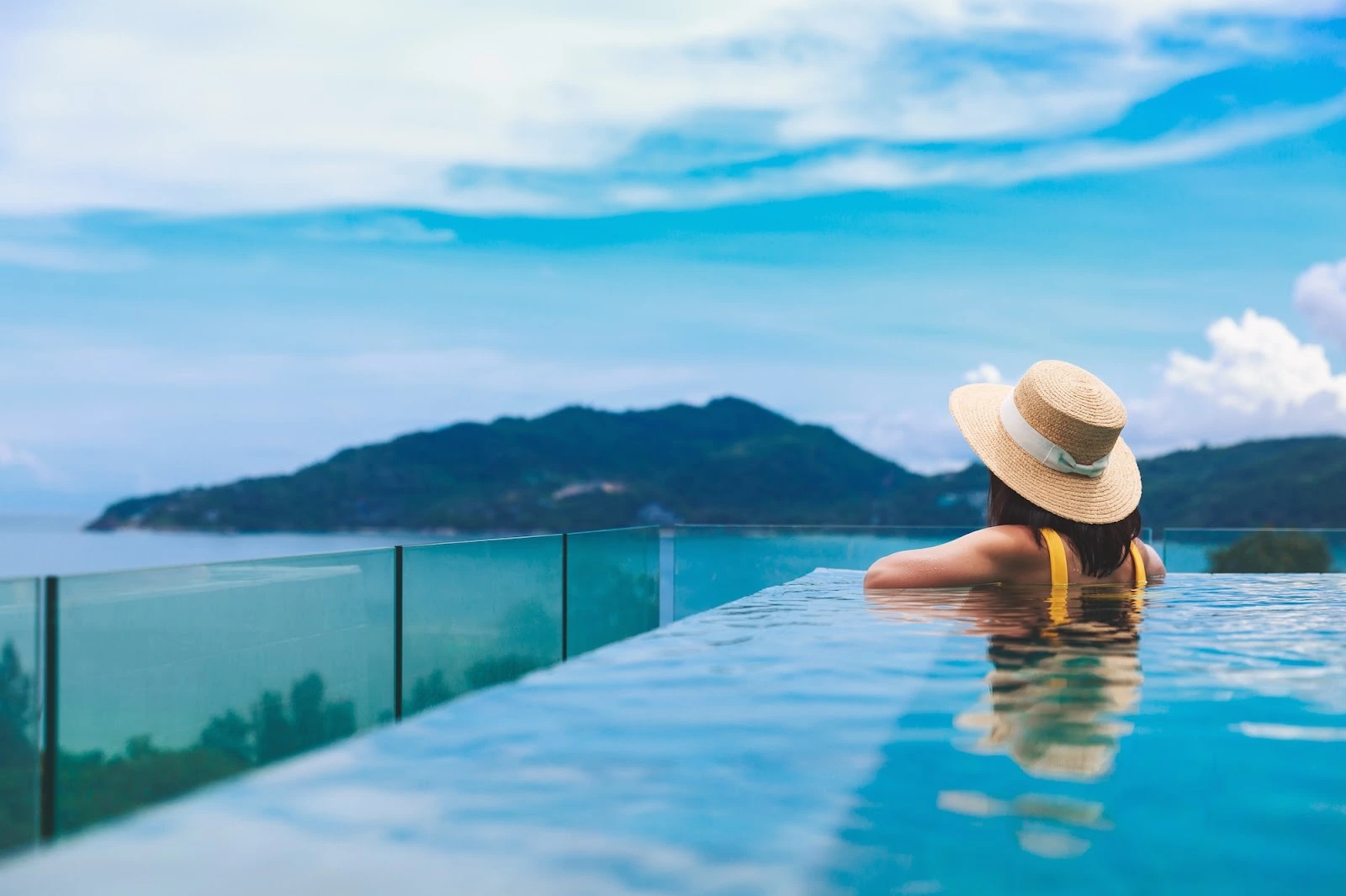 woman in a pool overlooking a mountain