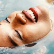 A woman relaxing in a pool of water.