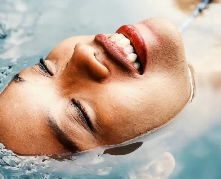 A woman relaxing in a pool of water.