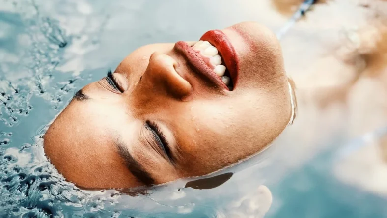 A woman relaxing in a pool of water.