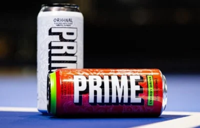 Prime Energy cans on a blue pickleball court