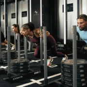 people push weight sleds inside a Hyrox training facility