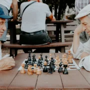 Two senior men playing chess together.