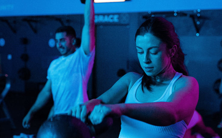 Clients working out under blue lights in RevFit.