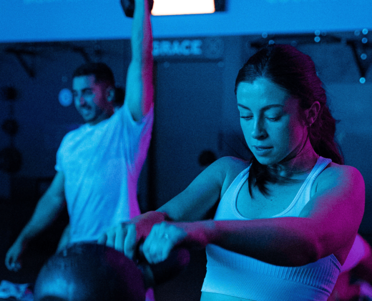 Clients working out under blue lights in RevFit.