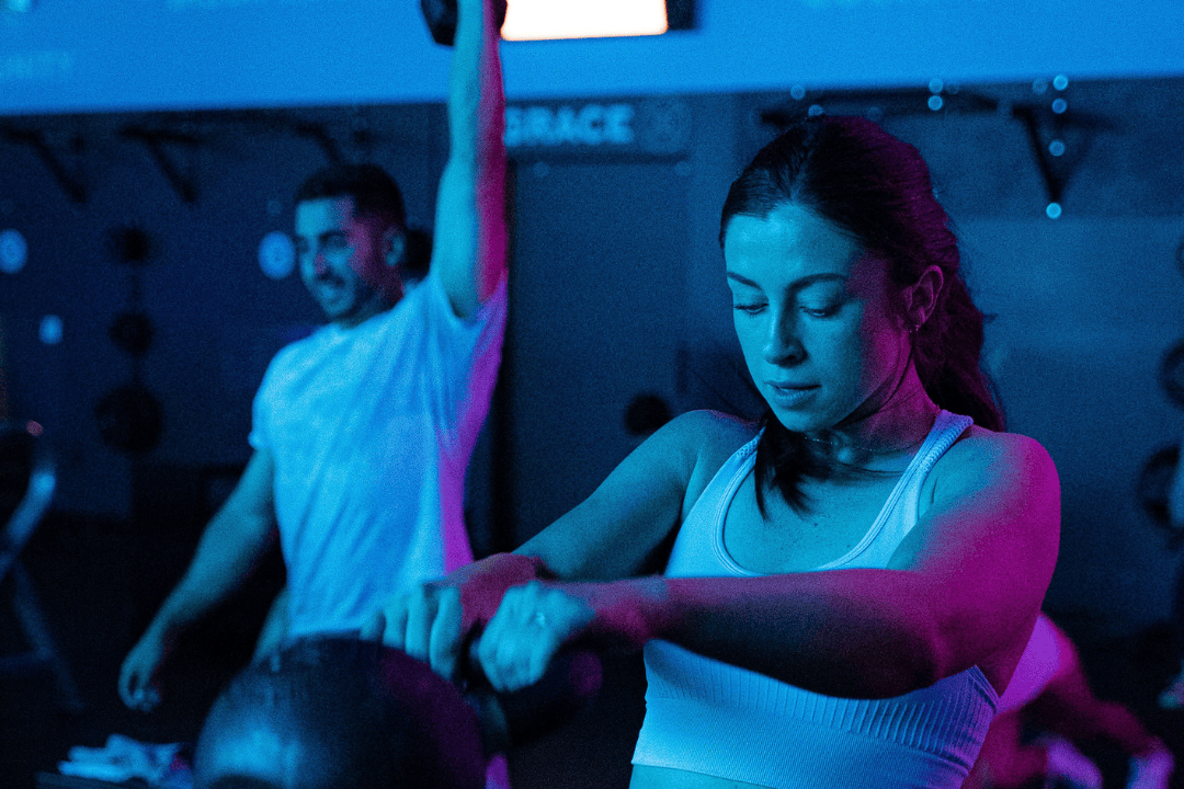Clients working out under blue lights in RevFit.