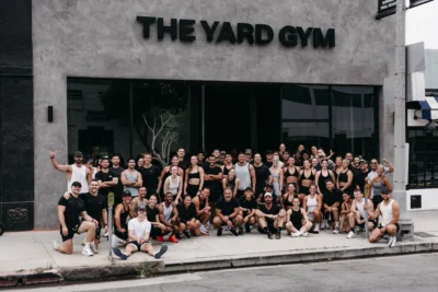 people line up for a photo outside of The Yard Gym