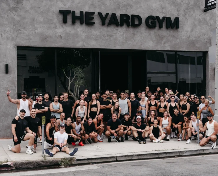 people line up for a photo outside of The Yard Gym