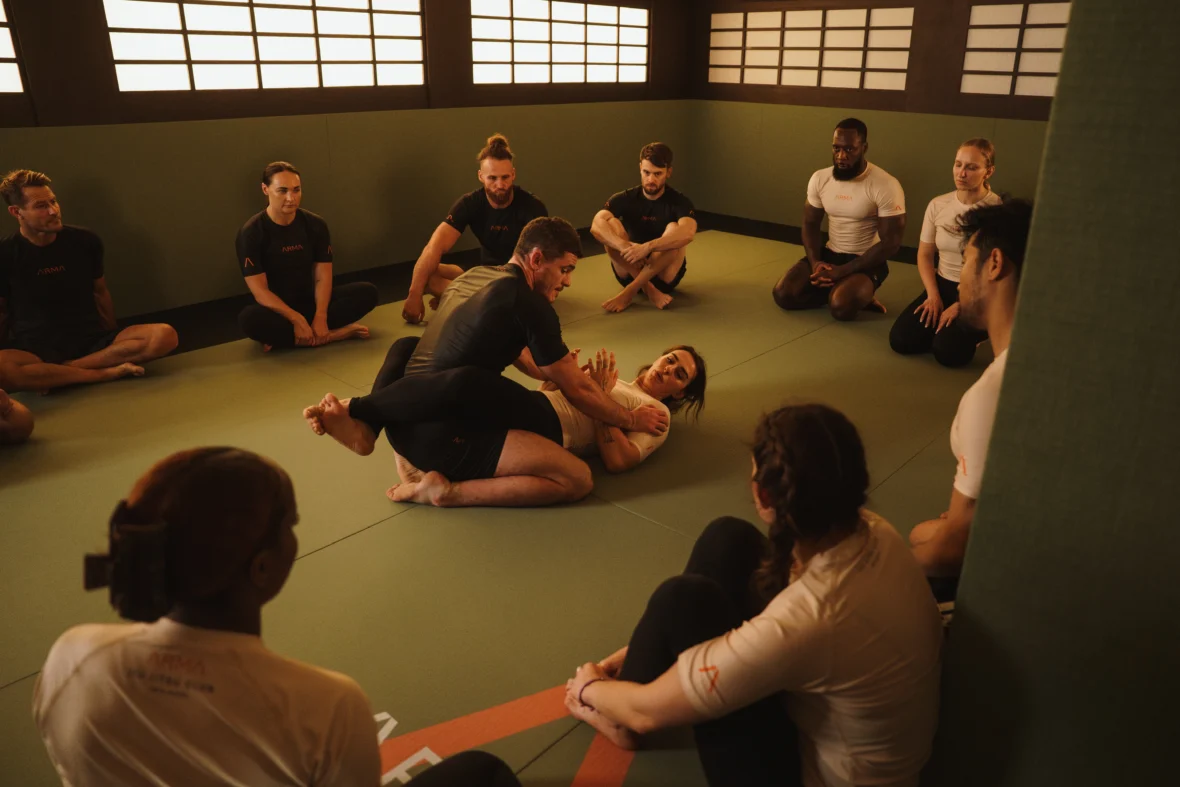 people do Brazilian jiu jitsu inside a studio