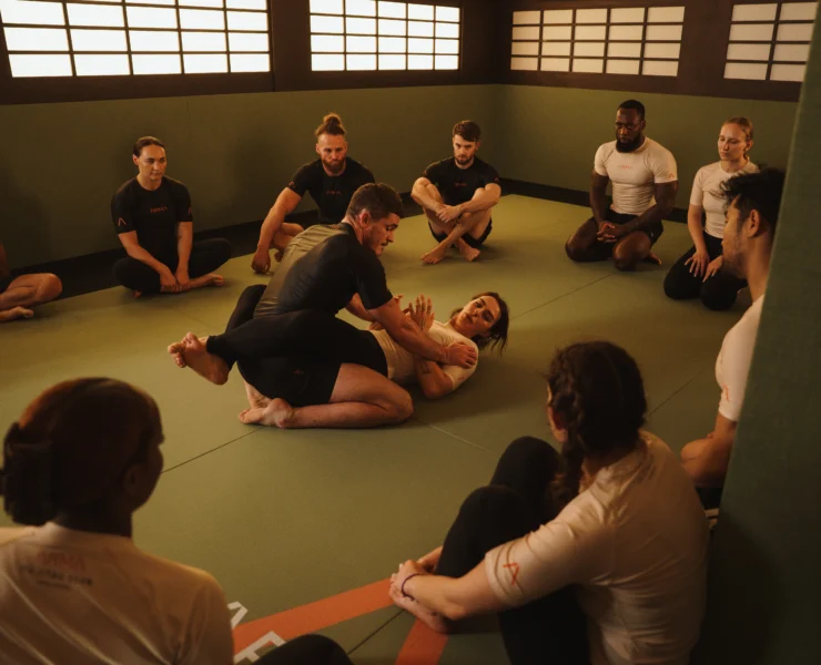 people do Brazilian jiu jitsu inside a studio