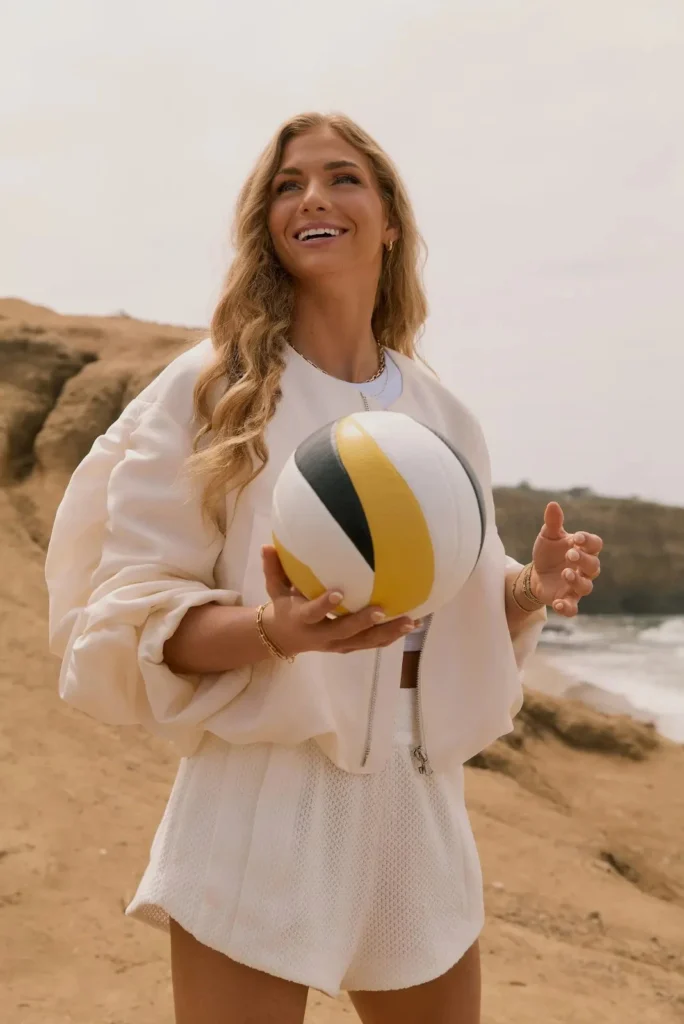woman with volleyball on beach