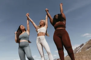 women raise their arms in celebration