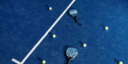 padel racquets and balls on court