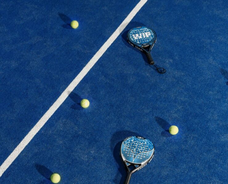 padel racquets and balls on court