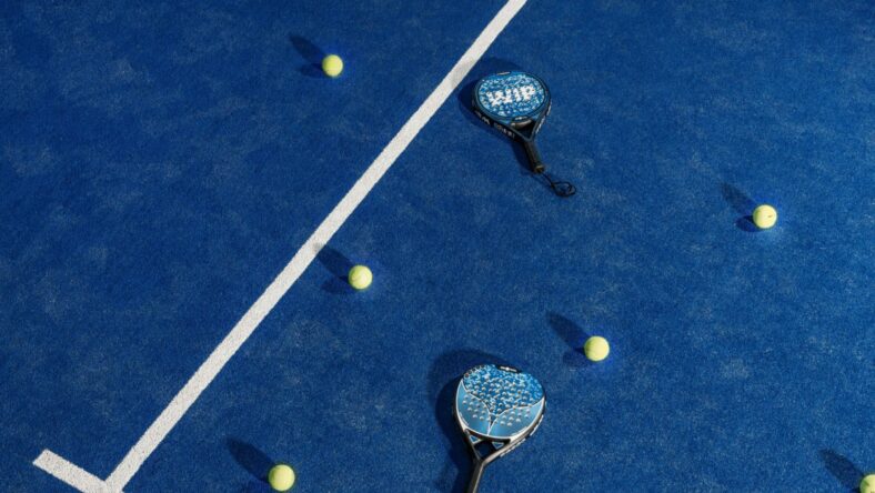 padel racquets and balls on court