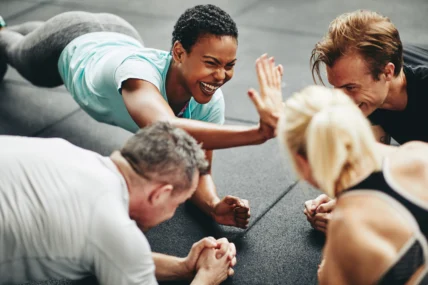 people high five each other while working out