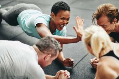 people high five each other while working out