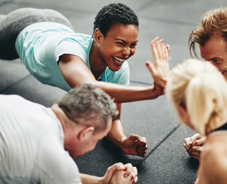 people high five each other while working out