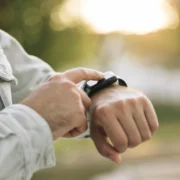 man taps on his Apple Watch