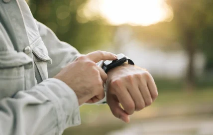 man taps on his Apple Watch