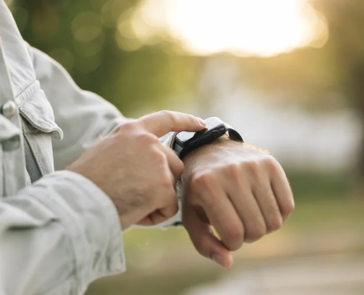 man taps on his Apple Watch
