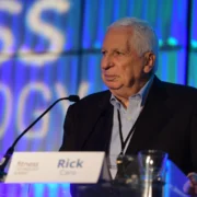 Rick Caro speaks on stage