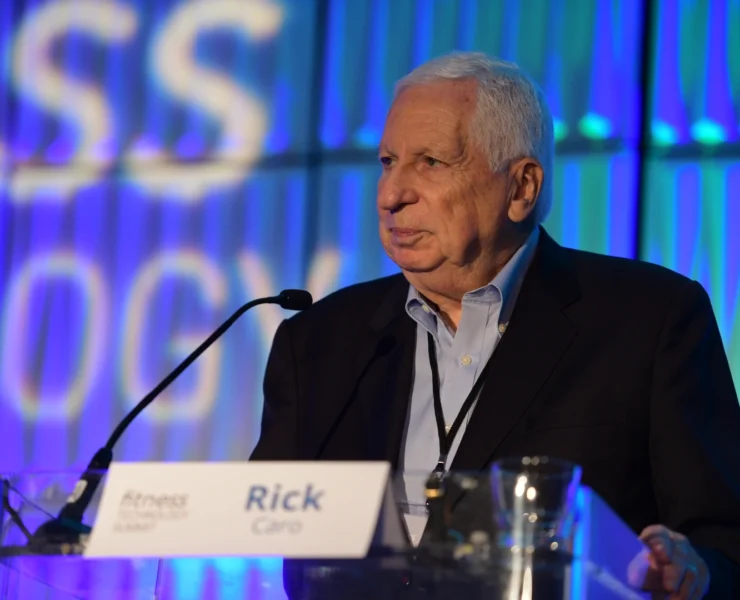 Rick Caro speaks on stage