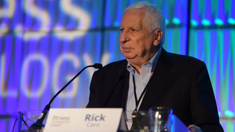 Rick Caro speaks on stage