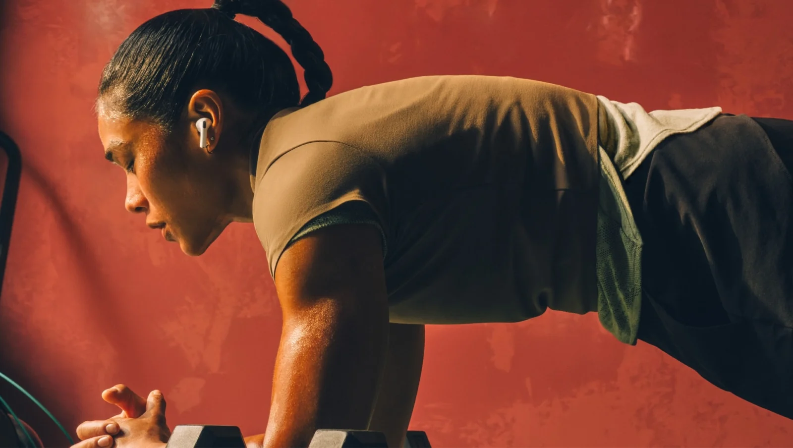 woman does a plank wearing Airpods