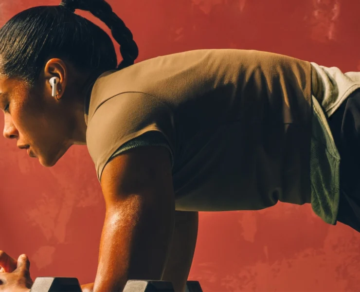 woman does a plank wearing Airpods
