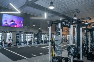 PLAE equipment and an LG tv inside a Fitness2020 gym
