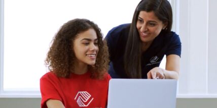 Boys & Girls Clubs member and staff memer on laptop