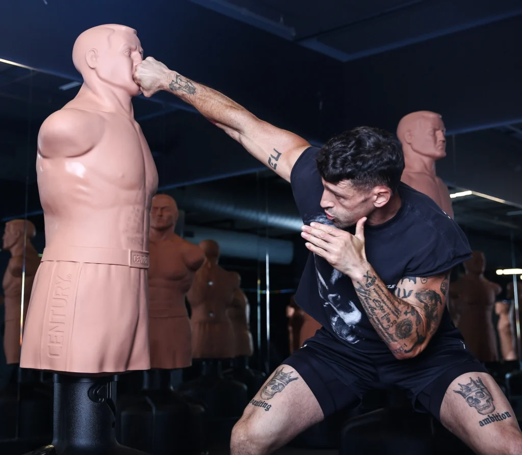 man punches a body opponent bag