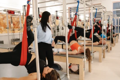 women work out on Pilates reformers