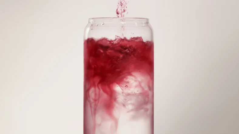 woman pours supplement powder into a drink