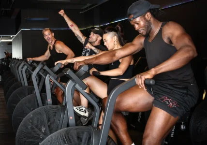 people work out on assault bikes