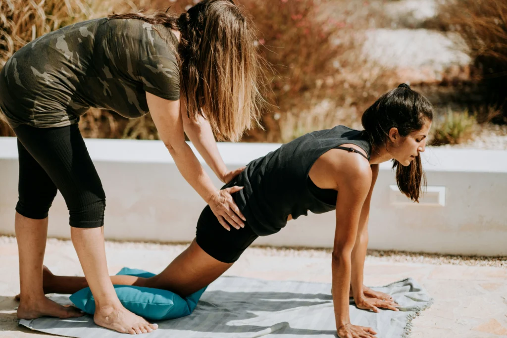 woman does an exercise with her personal trainer