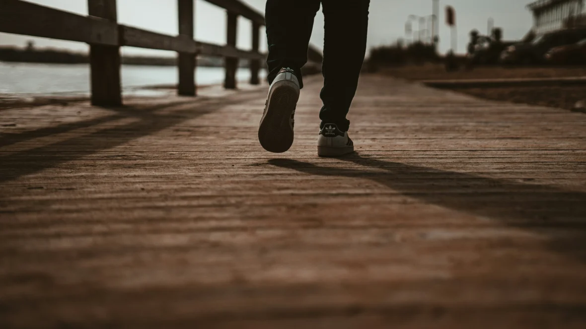 man walks on a boardwalk