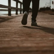 man walks on a boardwalk