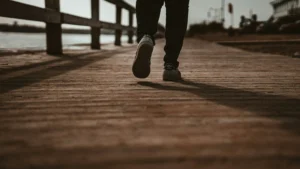 man walks on a boardwalk