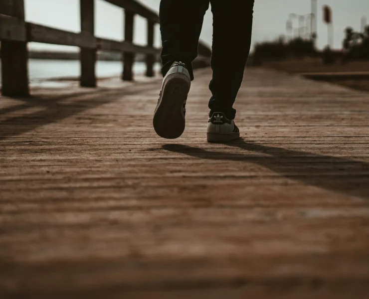 man walks on a boardwalk