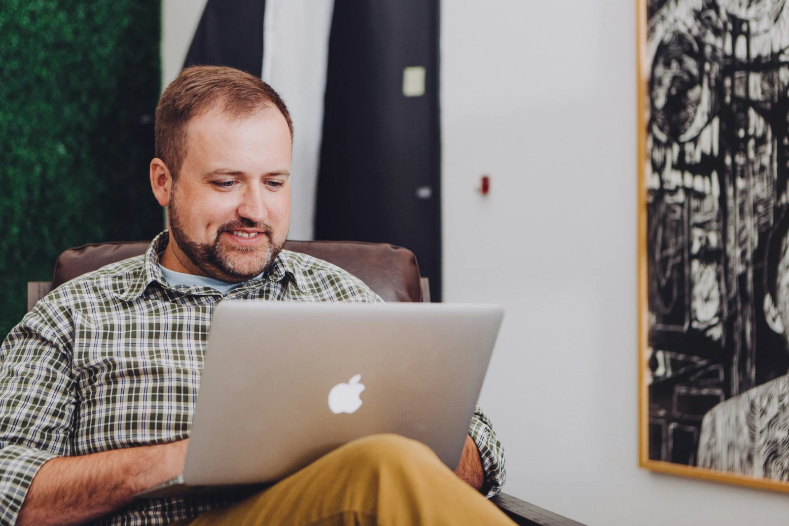 man types on Macbook