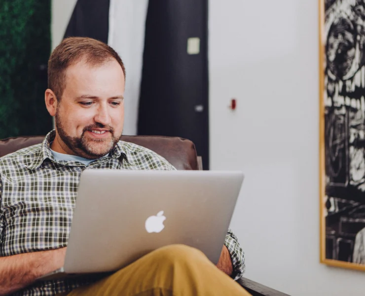 man types on Macbook