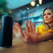 woman pushes away a can of liquid