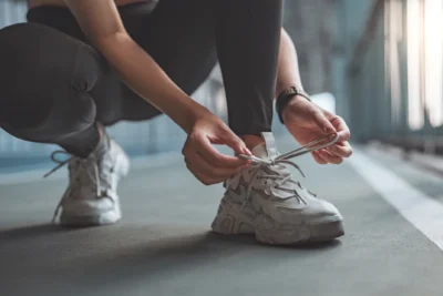 woman ties her sneaker