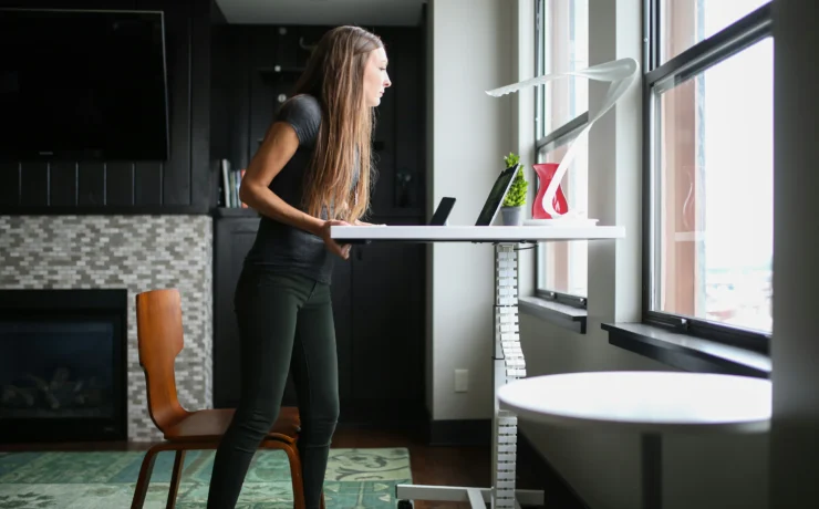woman works at a standing desk